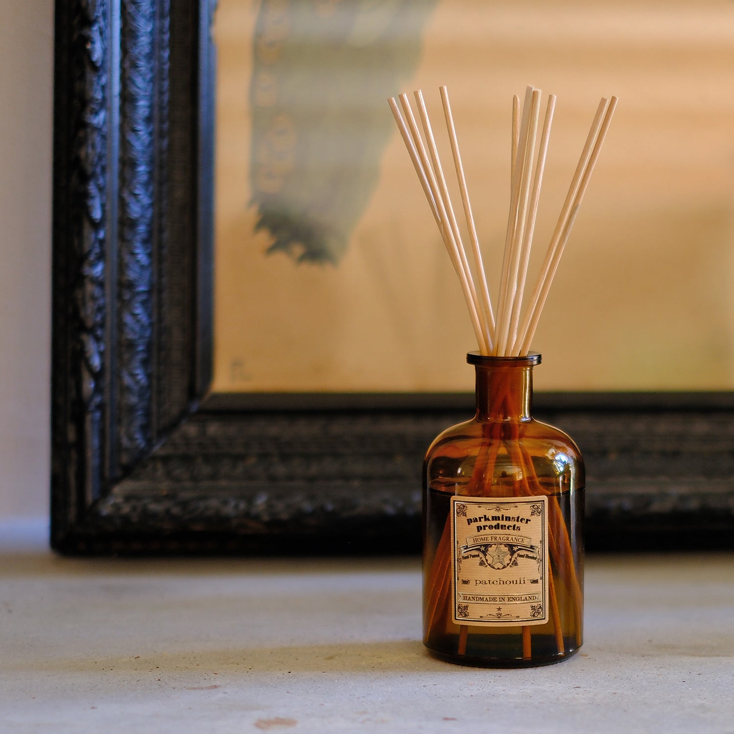 Elevate your home with the earthy Patchouli Scented Amber Glass Apothecary Collection 200ml Reed Diffusers by Parkminster Home Fragrance Co (Cornwall). Made with 100% essential oil, these diffusers provide a rich, grounding aroma that enhances any space.