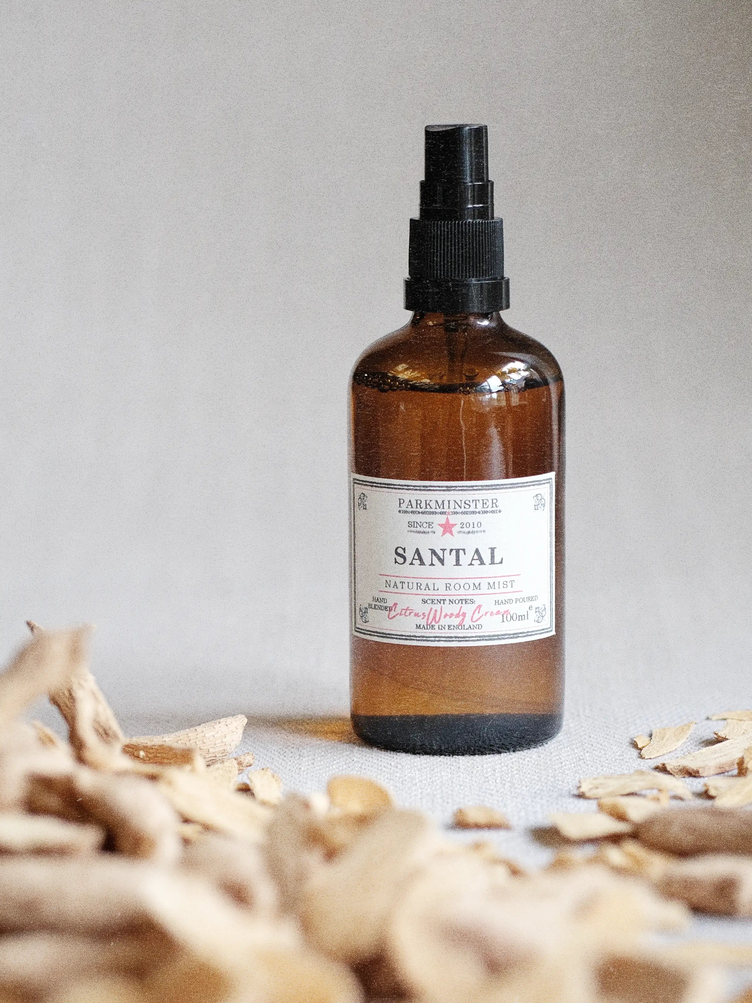 Parkminster Santal room mist spray with citrus woody cream fragrance notes, natural plant-based home fragrance in an amber glass bottle creating a calm and softly scented interior atmosphere