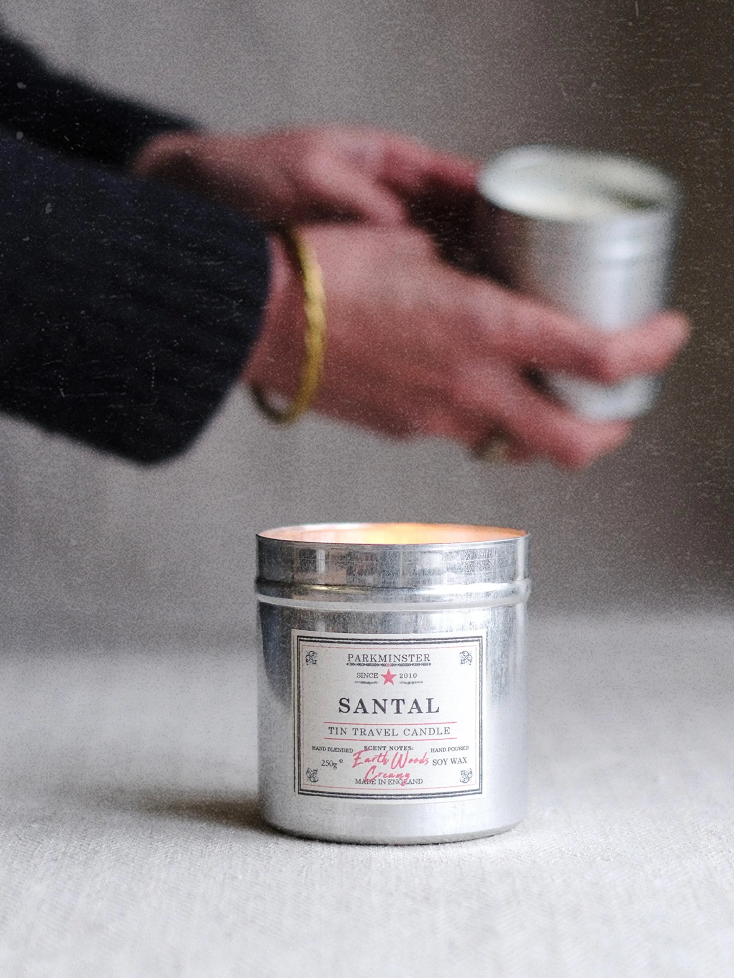 Parkminster Santal scented tin candle made with natural soy wax, featuring citrus woody cream fragrance notes for a warm natural home fragrance