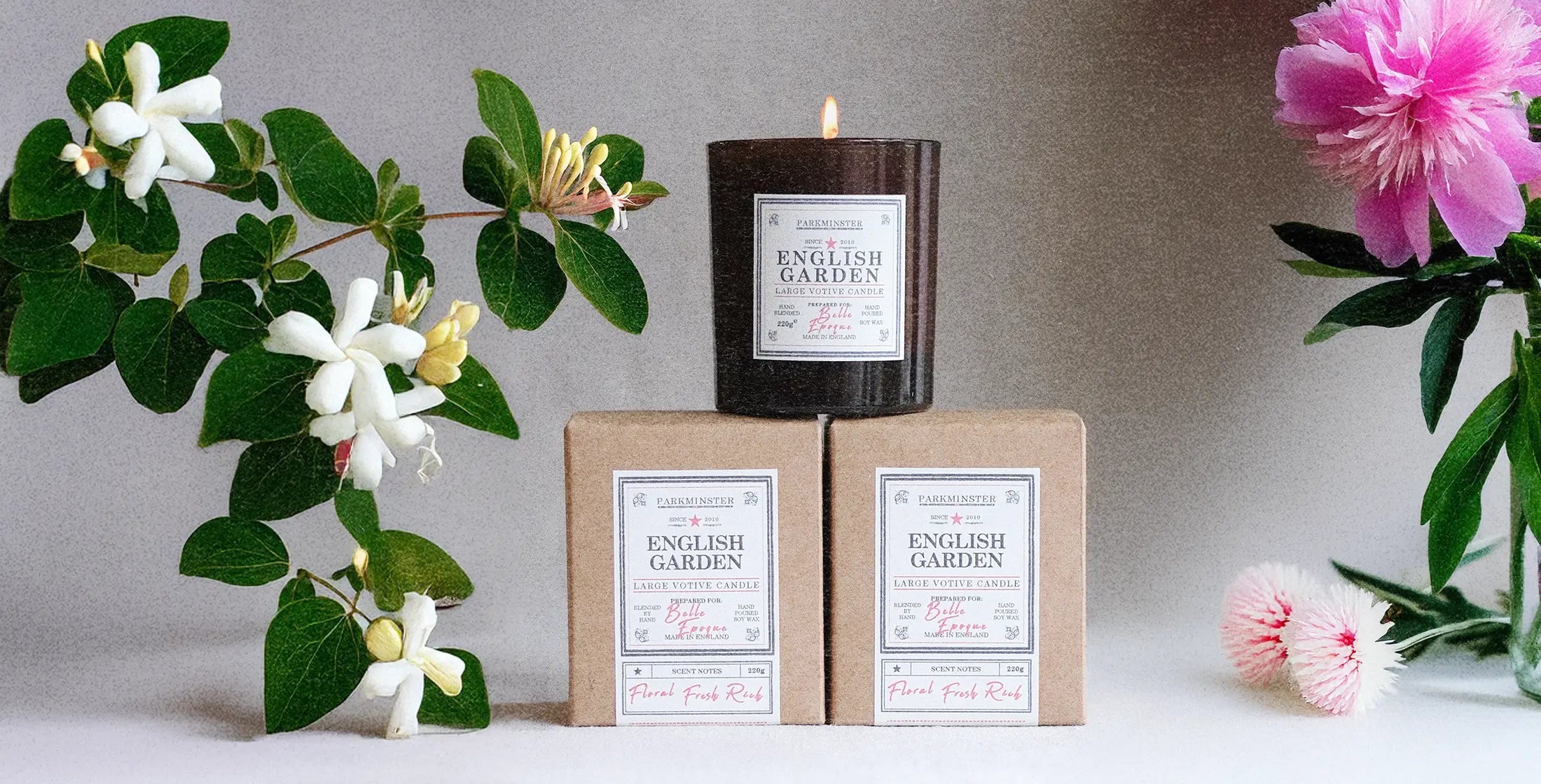 a Parkminster ENGLISH GARDEN Large Votive Candle in a calming natural setting with botanical honeysuckle, jasmine, and fresh cut flowers – natural floral candle