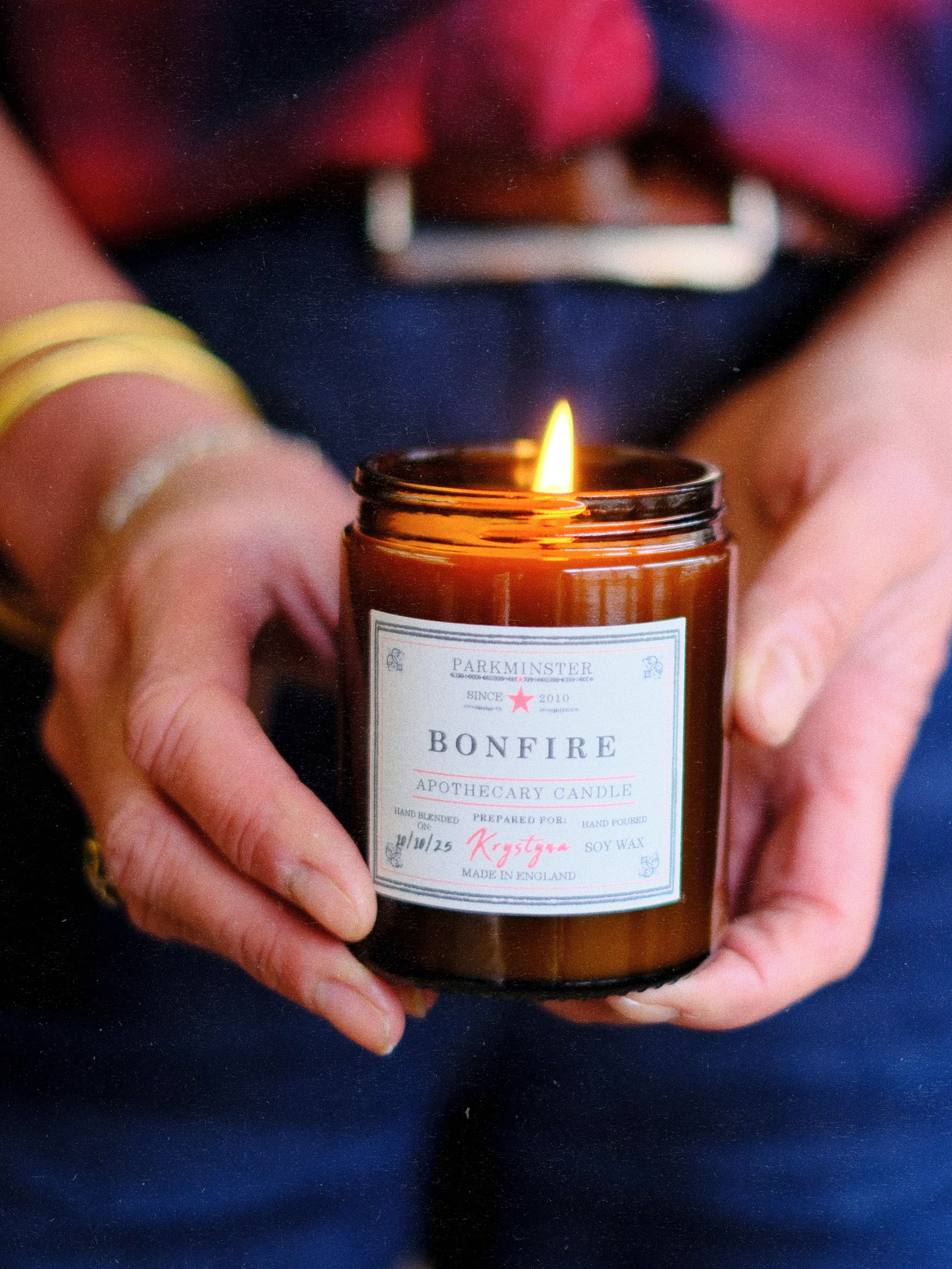 Amber glass Bonfire Apothecary Candle by Parkminster Home Fragrance Co, a smoky autumnal candle ideal as a thoughtful seasonal gift or home comfort.