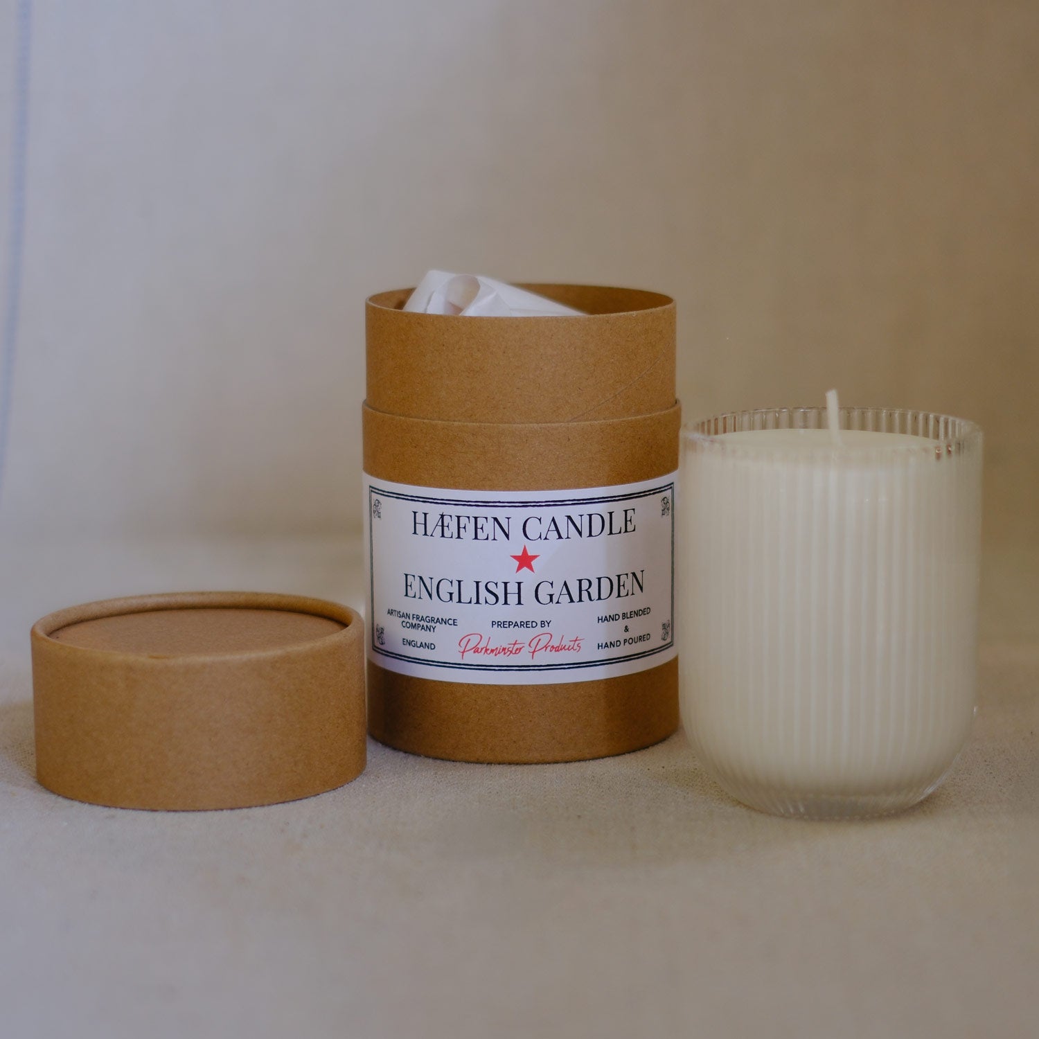 Parkminster English Garden scented HAVEN Candle in elegant ribbed glassware and recyclable kraft tube packaging. A floral blend of jasmine, honeysuckle, and fruit trees for a serene, inviting atmosphere.