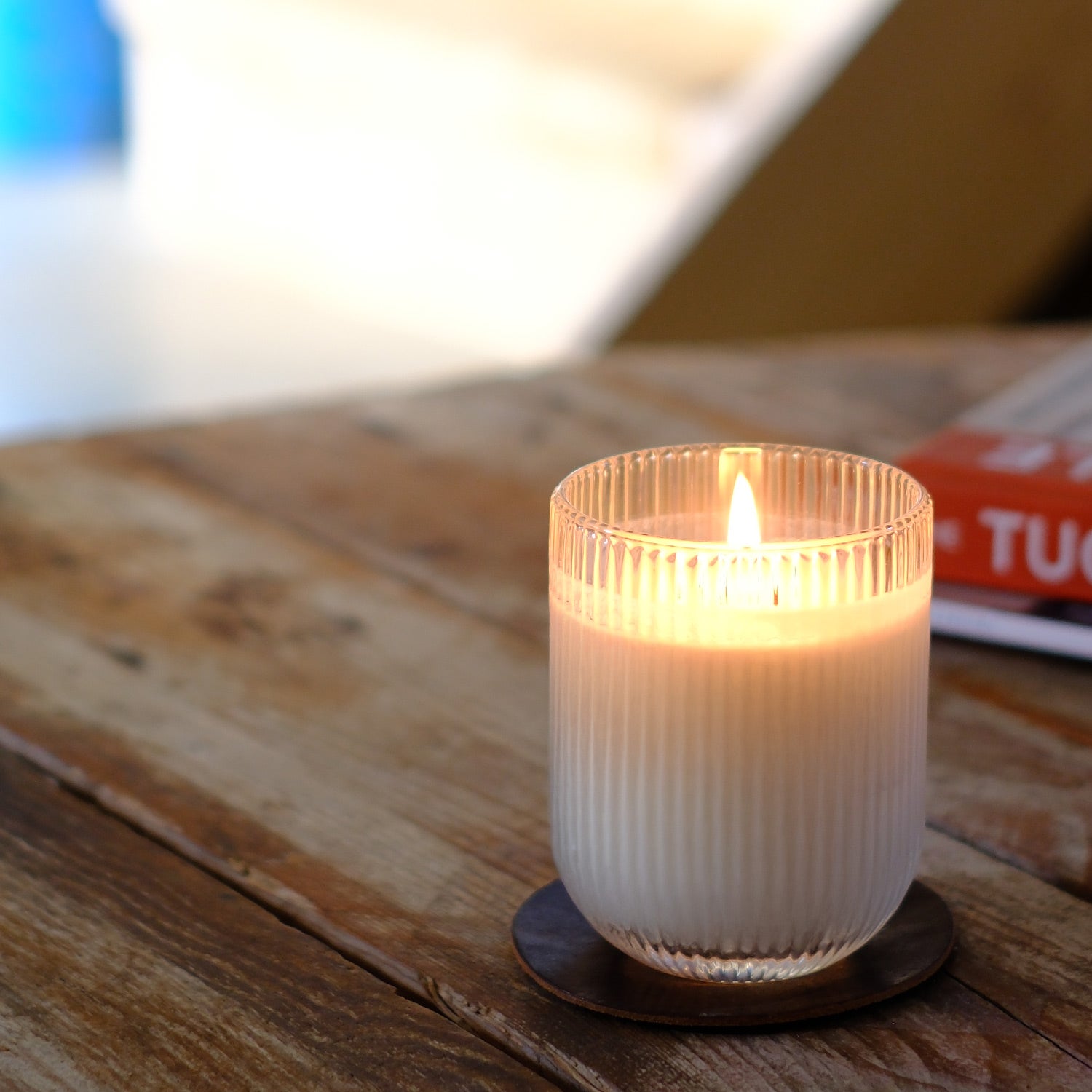A Parkminster HÆFEN scented candle in Eucalyptus, crafted from natural soy wax, with elegant ribbed glassware and refreshing minty, woody, citrus notes.