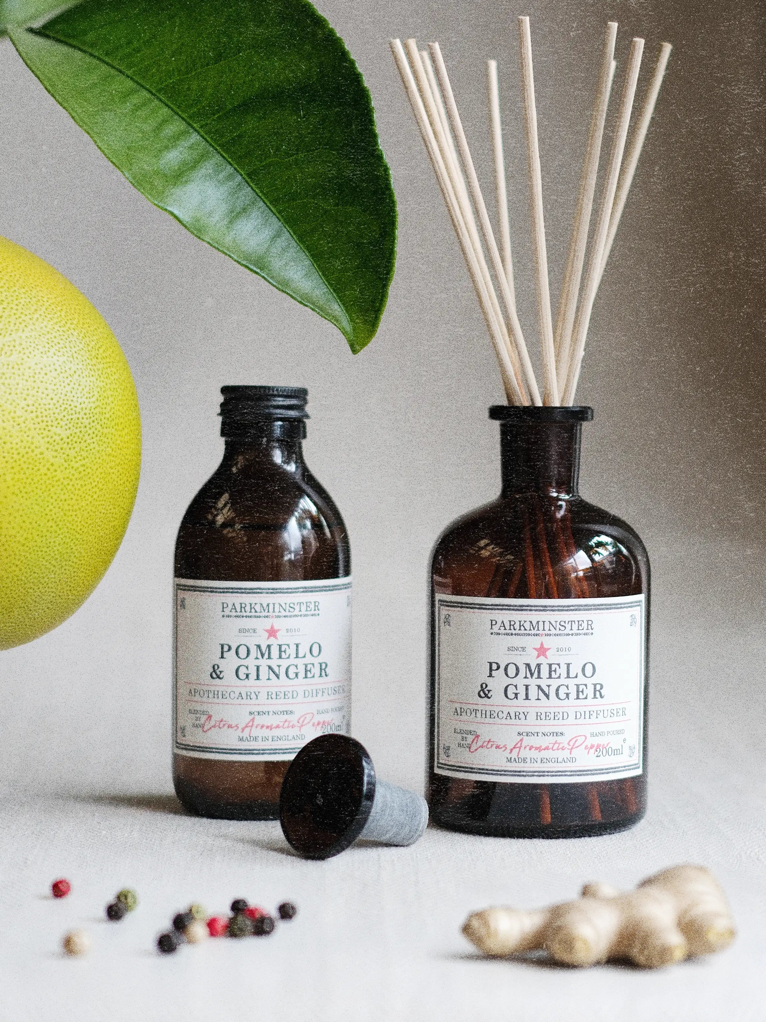Parkminster Pomelo & Ginger 200ml apothecary reed diffuser in amber glass bottle with natural rattan reeds, citrus and spicy home fragrance.