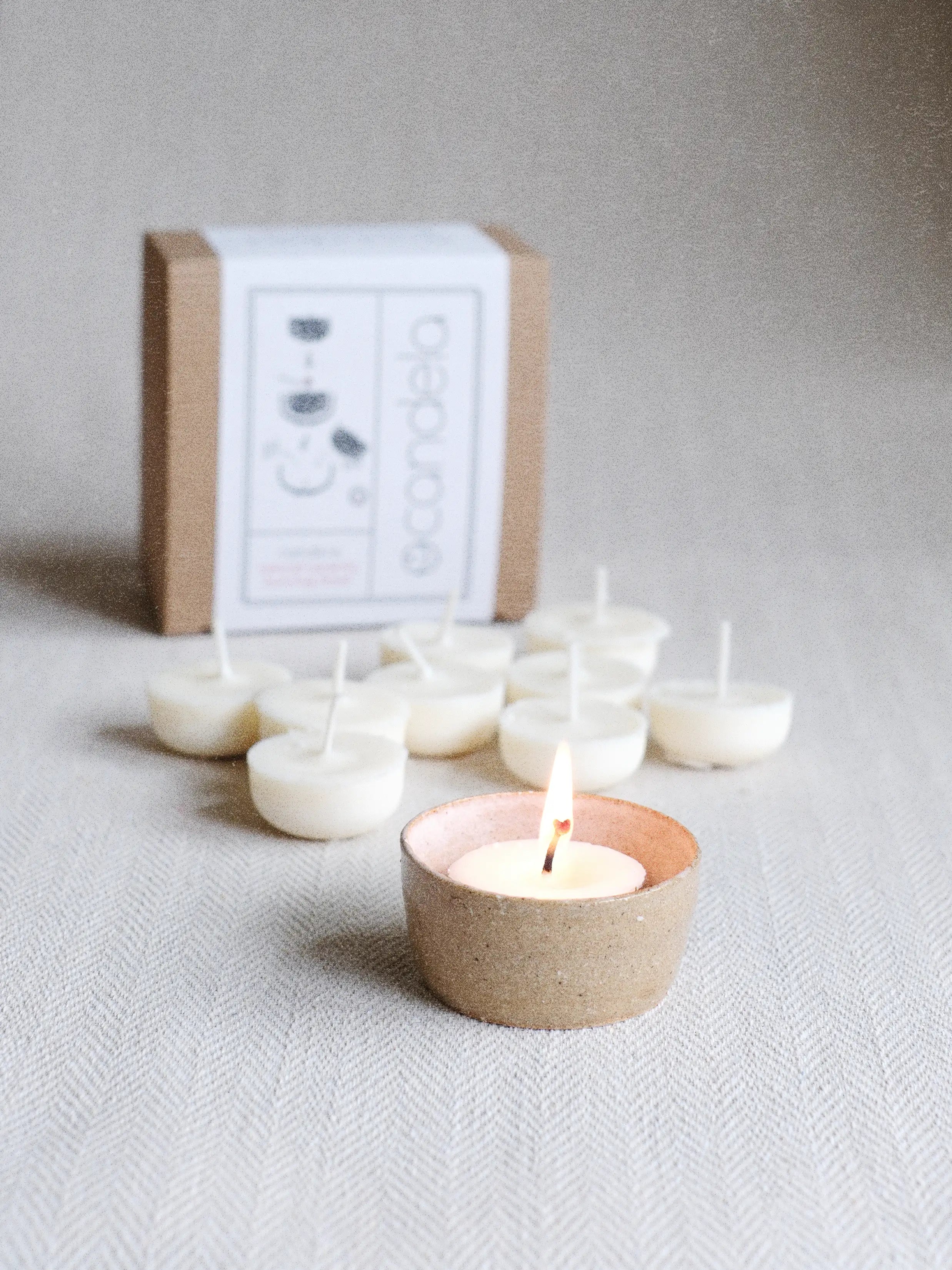 Small natural soy wax candle burning in a reusable ceramic bowl, an elegant alternative to scented tea lights for sustainable home fragrance