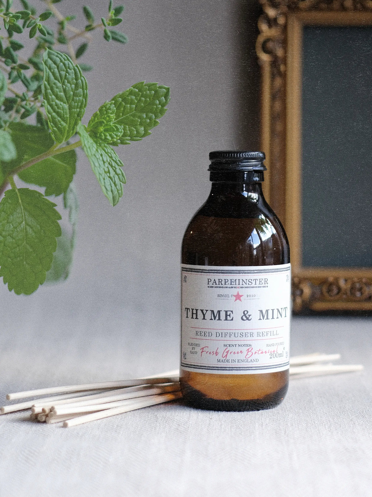 Thyme & Mint reed diffuser refill in amber glass jar with vintage label, featuring a fresh herbal essential oil fragrance