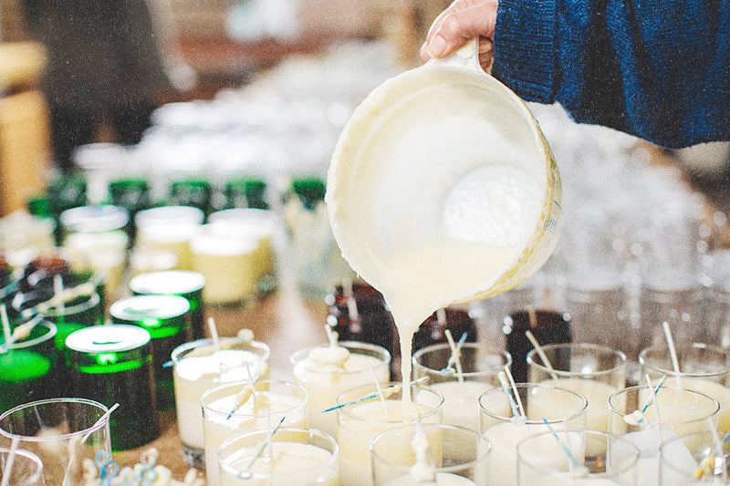 A Parkminster team member hand pouring scented soy wax candles in the Fragrance Workshop
