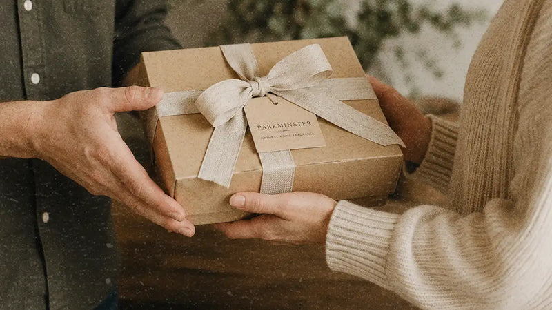 Woman giving a Parkminster Candle Gift Set as a Christmas present to a friend
