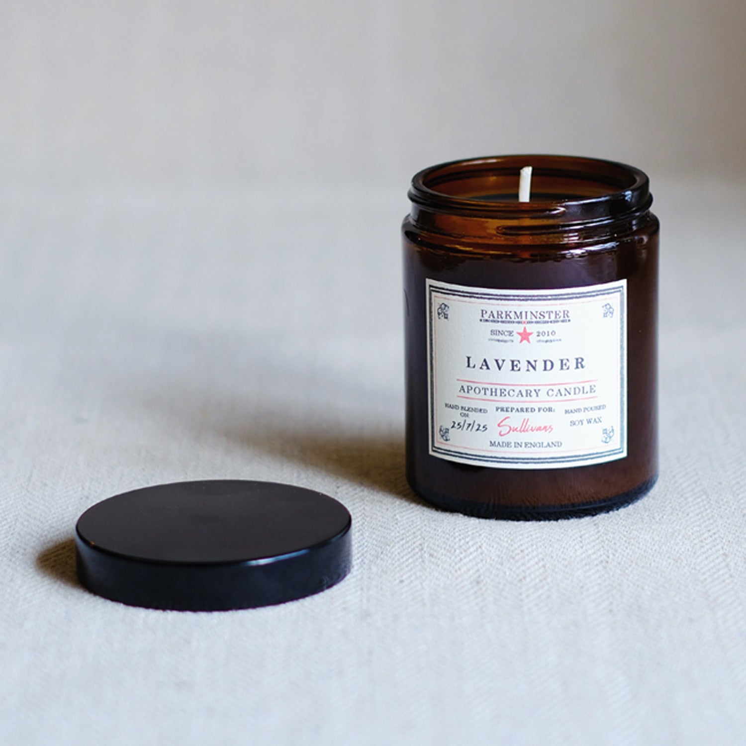 Lavender scented essential oil candle in amber glass jar with black screw lid – calming travel candle gift for her