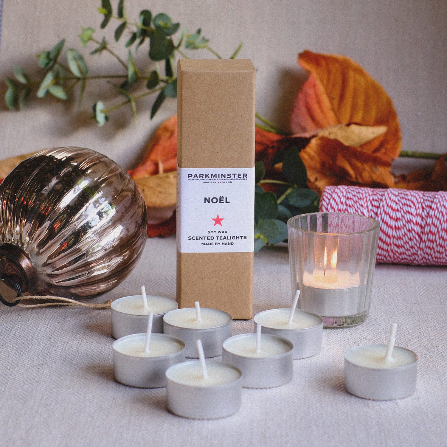 Noël scented tealight candles by Parkminster, hand-poured in the UK with festive notes of orange, clove, and cinnamon; pack of 8