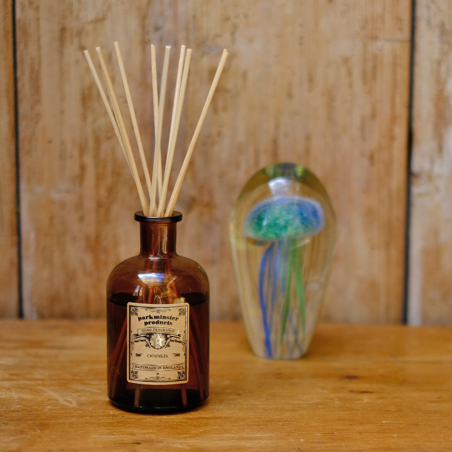 Bring the invigorating ocean breeze into your home with the Ocean Scented Amber Glass Apothecary Collection 200ml Reed Diffusers by Parkminster Home Fragrance Co (Cornwall). These diffusers offer a crisp, salty fragrance reminiscent of a windy beach walk.
