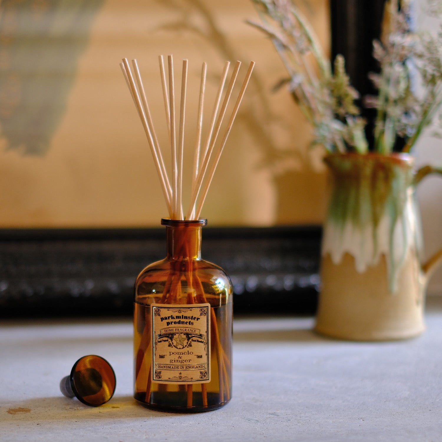 Infuse your home with the lively scent of Pomelo & Ginger using the Amber Glass Apothecary Collection 200ml Reed Diffusers by Parkminster Home Fragrance Co (Cornwall). These diffusers offer a rich blend of citrus and spice, perfect for a refreshing and warm ambiance.