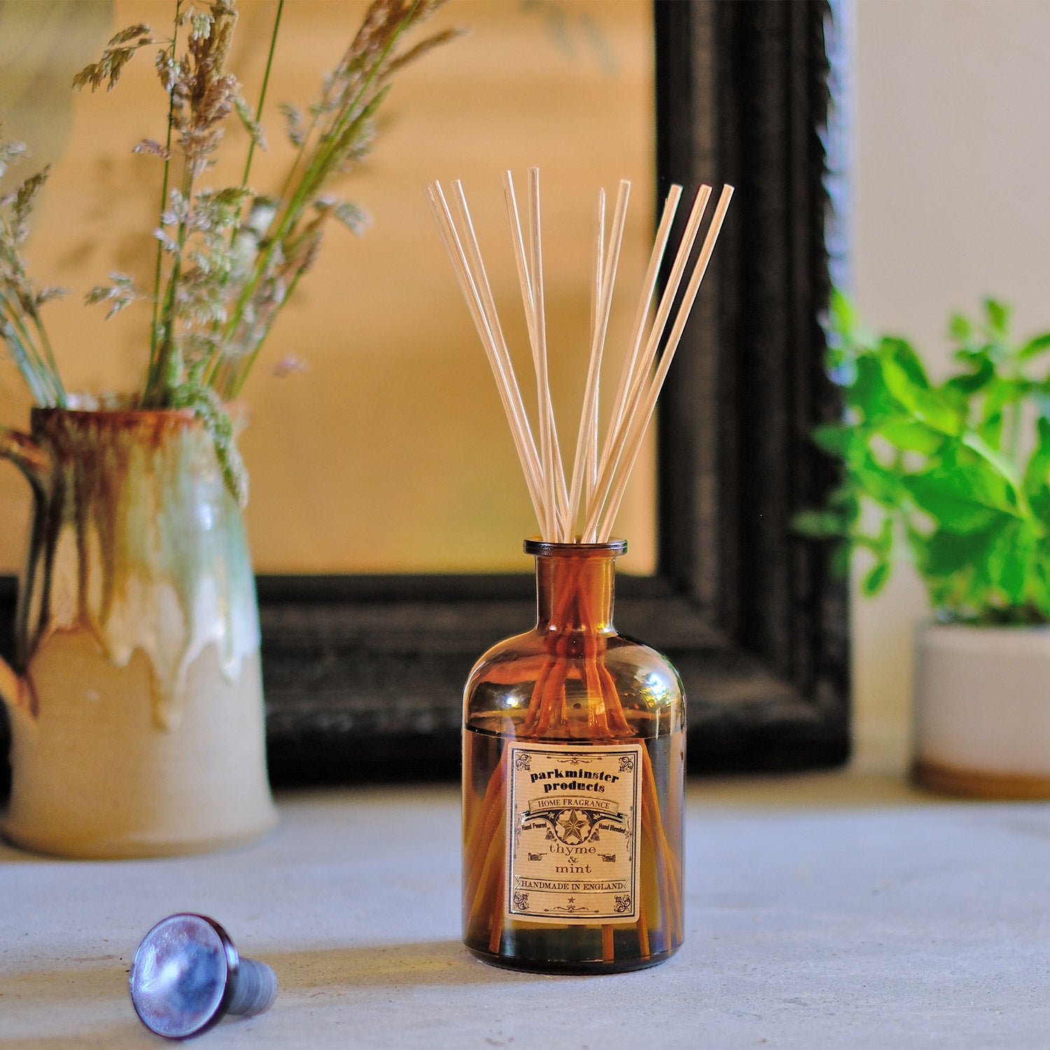 Infuse your home with the vibrant and herbal fragrance of Thyme & Mint from Parkminster's 200ml amber glass Apothecary Reed Diffuser. Made by hand in our Cornish workshop with 100% plant-based ingredients, this diffuser offers a modern and invigorating way to freshen your living space