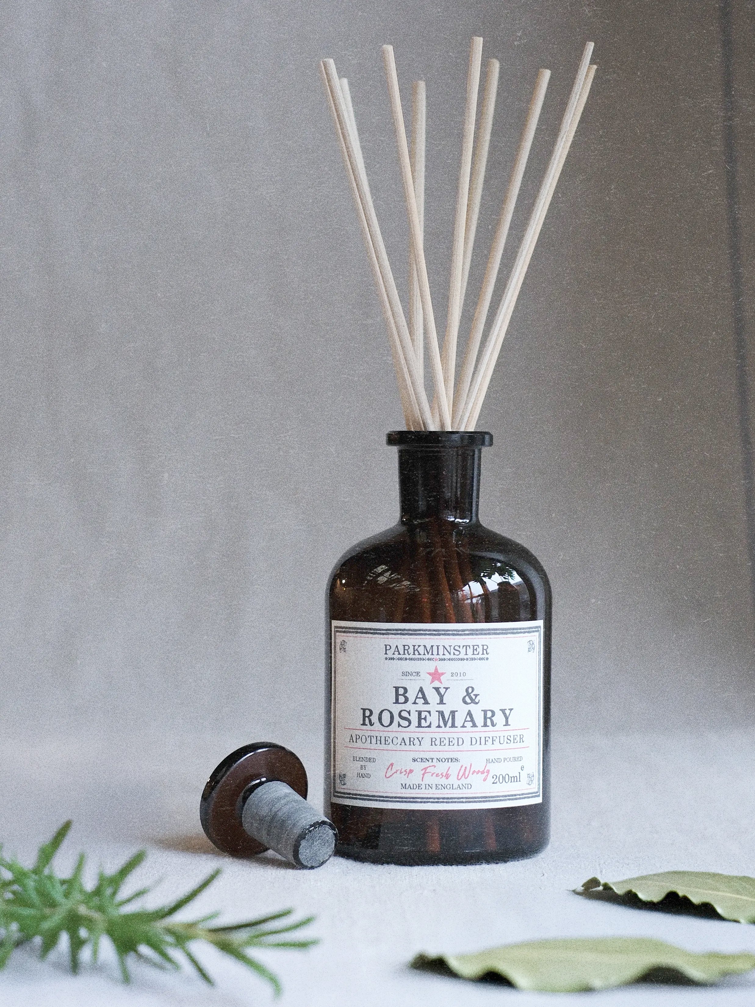 Bay & Rosemary Reed Diffuser from the Apothecary Collection (200ml). A glass diffuser bottle with natural reeds, offering a refreshing bay leaf and rosemary scent for a calming atmosphere.