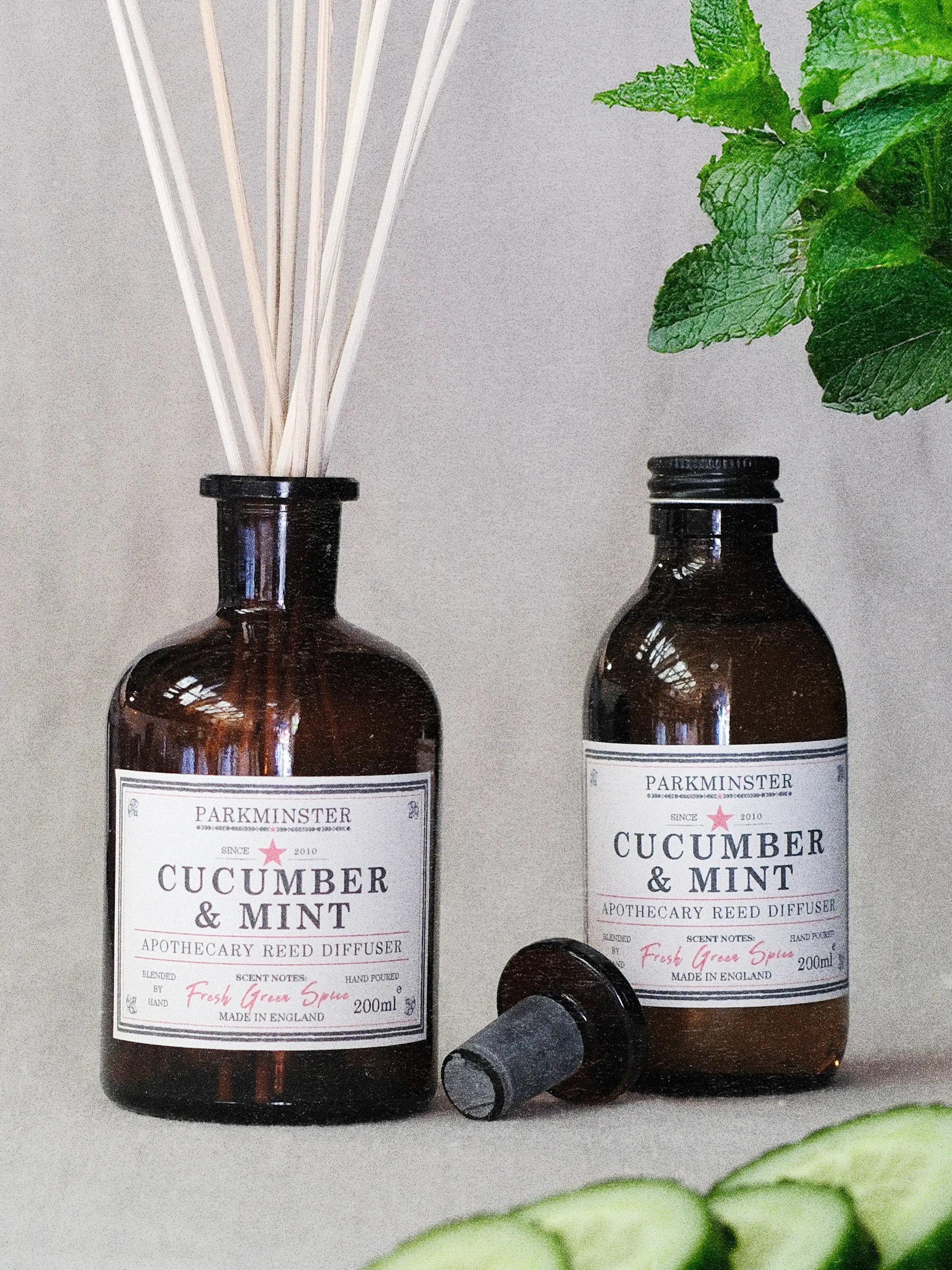 a 200ml Parkminster Cucumber and mint Apothecary Reed Diffuser in amber apothecary glass jar with a fresh natural fragrance, clean green scent for kitchens and bathrooms 