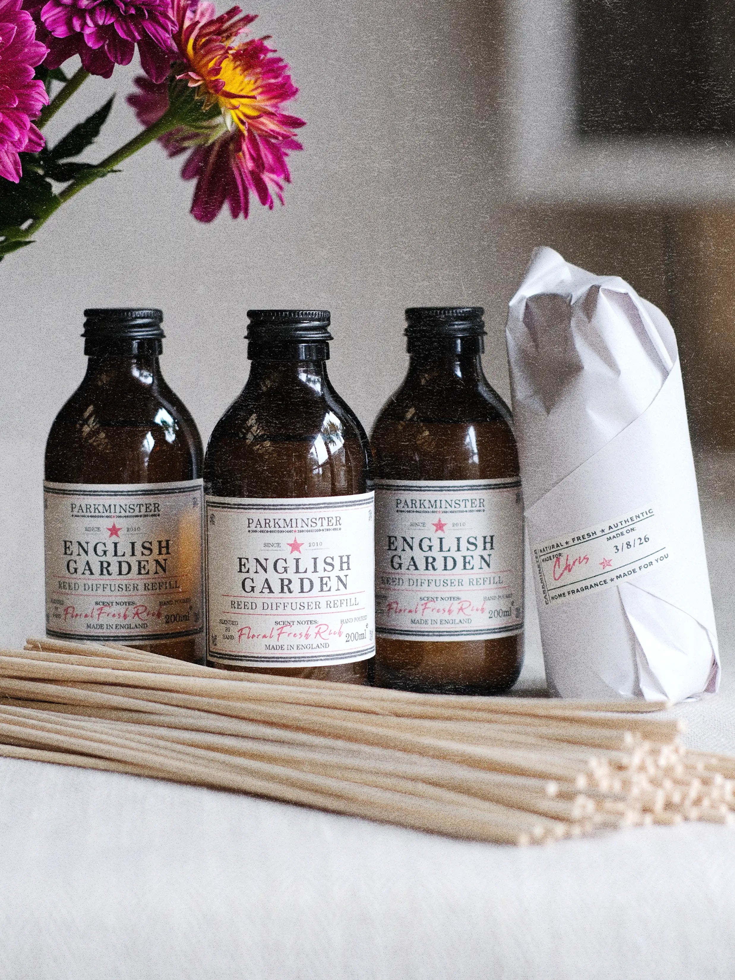 English Garden Reed Diffuser Refills in amber glass bottles with natural rattan reeds.