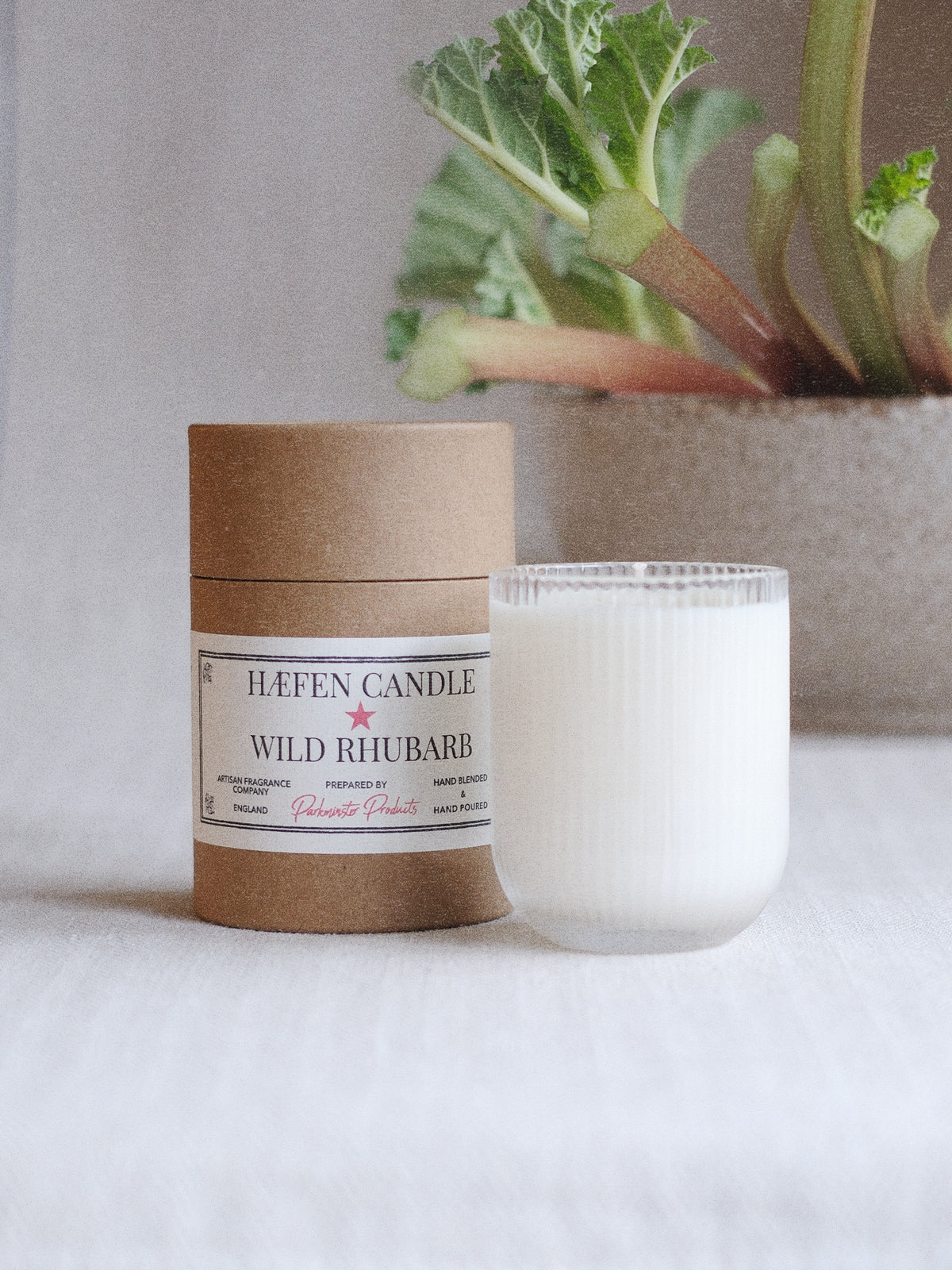 a Wild Rhubarb HÆFEN soy wax scented candle in ribbed glassware with a fresh, tangy fruity fragrance from Parkminster