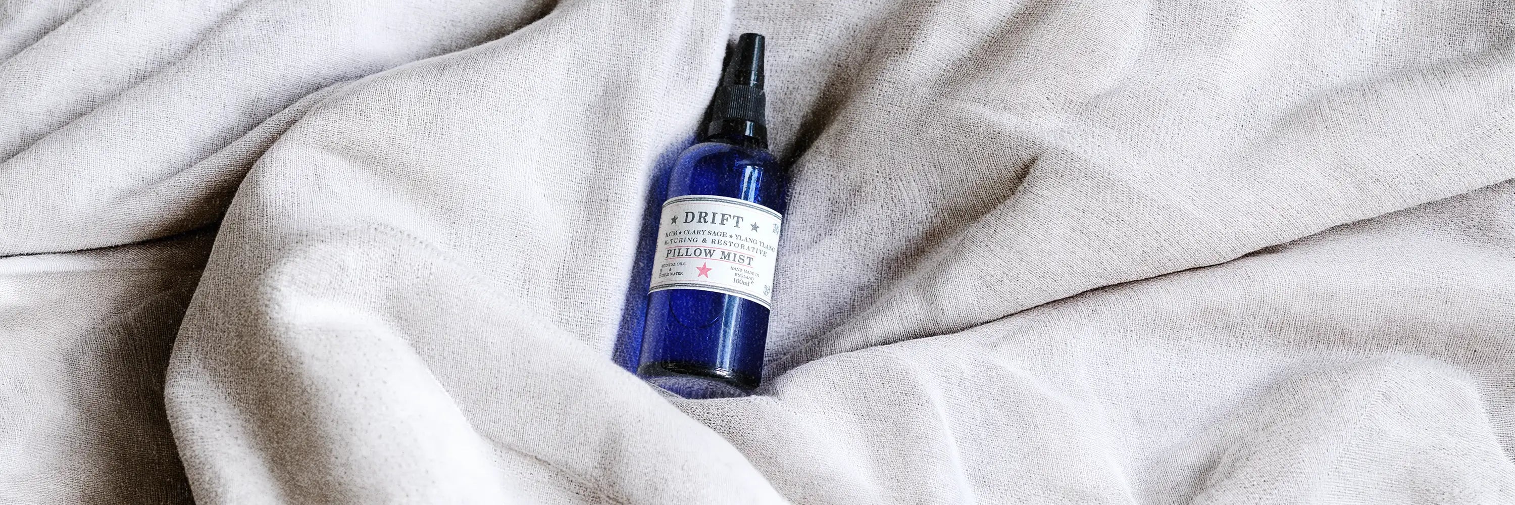 a Parkminster aromatherapy pillow spray in blue glass bottle made with essential oils for calming sleep mist ritual and gentle bedtime fragrance