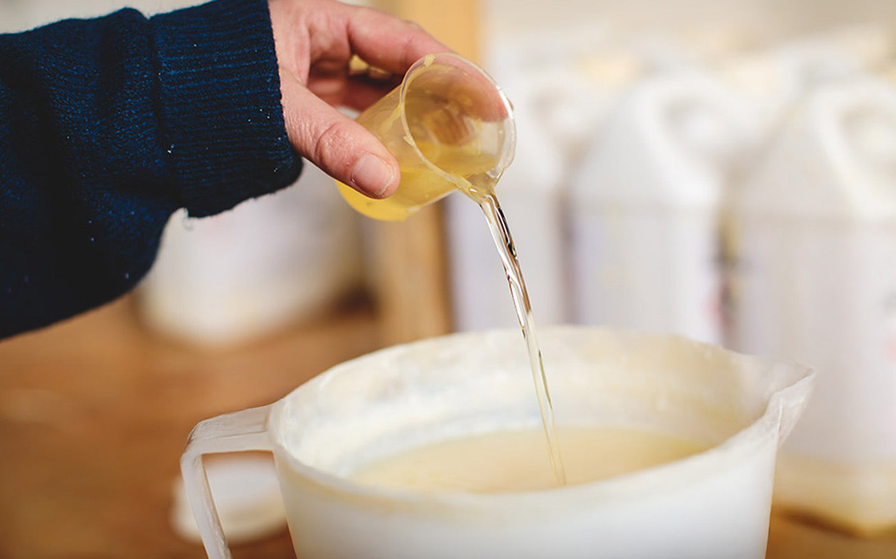 a Parkminster employee hand-blending fragrance oils into natural soy candles UK, eco-friendly botanical soy wax, handcrafted for home fragrance and candle gifts