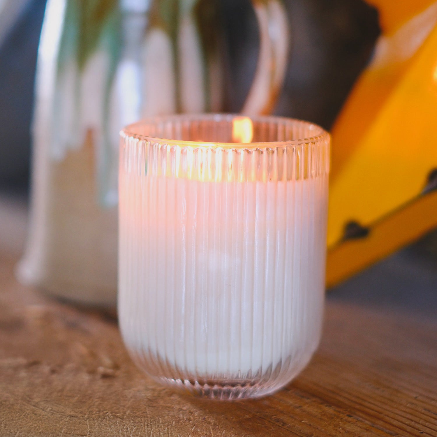 Parkminster MEADOW HAVEN Candle in ribbed glassware, blending floral, citrus, amber, and rose notes for a calming, serene ambiance.