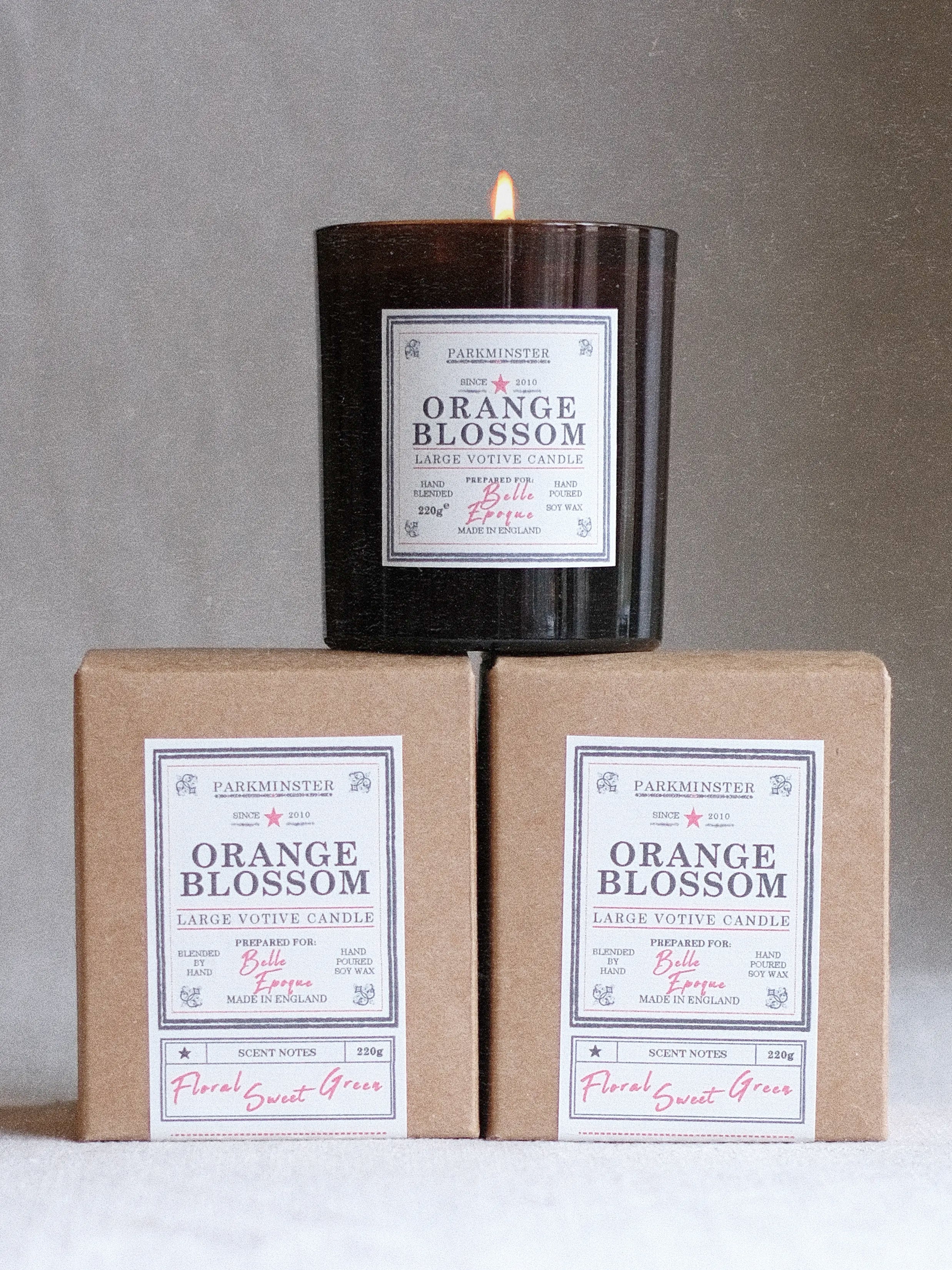 Parkminster Orange Blossom large votive soy candle (220g) in amber glass jar with recycled kraft box, floral-citrus fragrance of orange blossom, white petals, and citrus zest, personalised label option