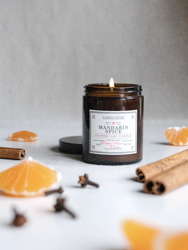 a Parkminster Mandarin Spice Apothecary Candle in vintage amber glass jar with natural soy wax and warm citrus spice fragrance of mandarin cinnamon and clove