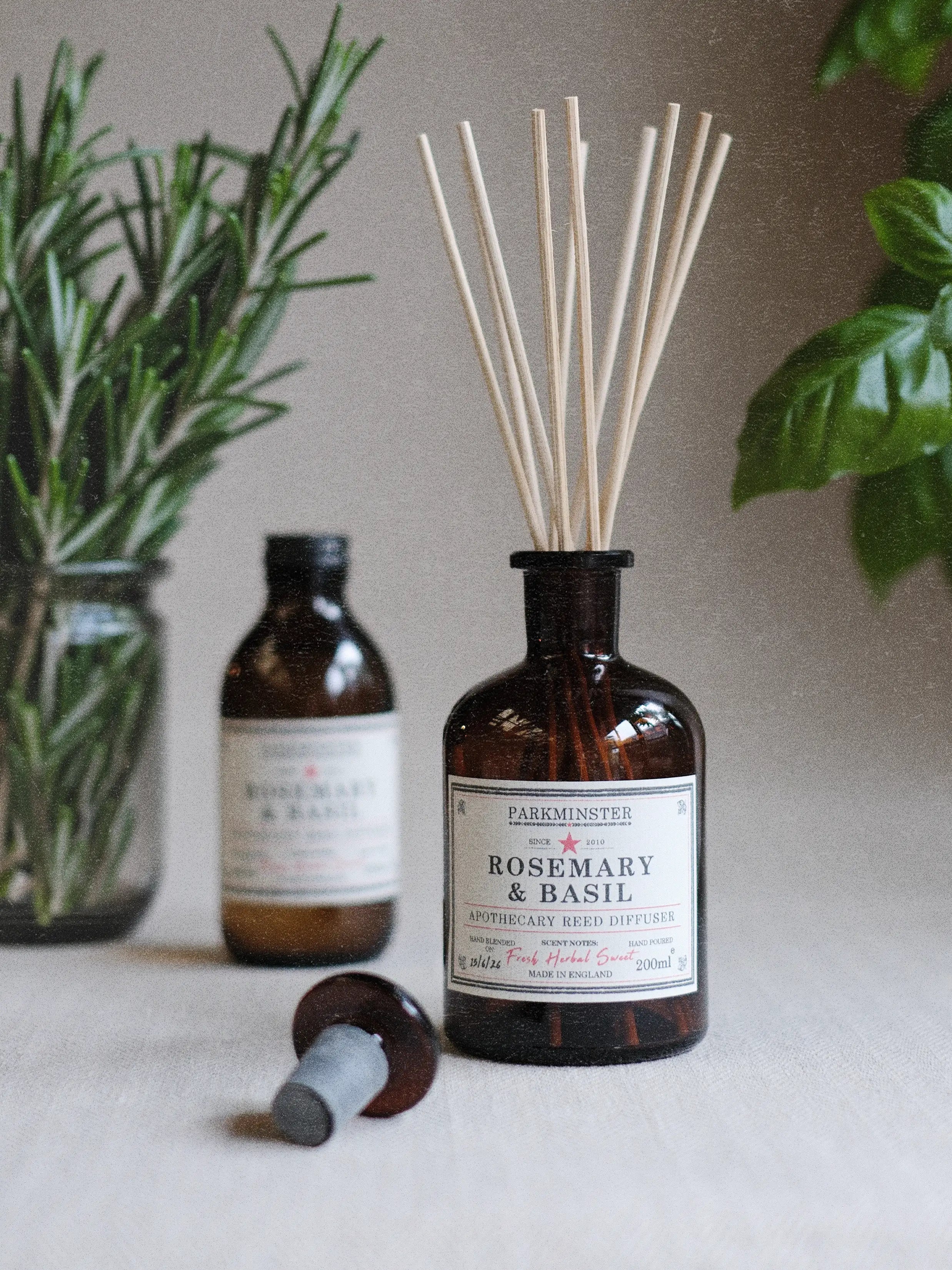 a Parkminster Rosemary and Basil Reed Diffuser with 100% essential oils in apothecary style glass bottle with natural reeds