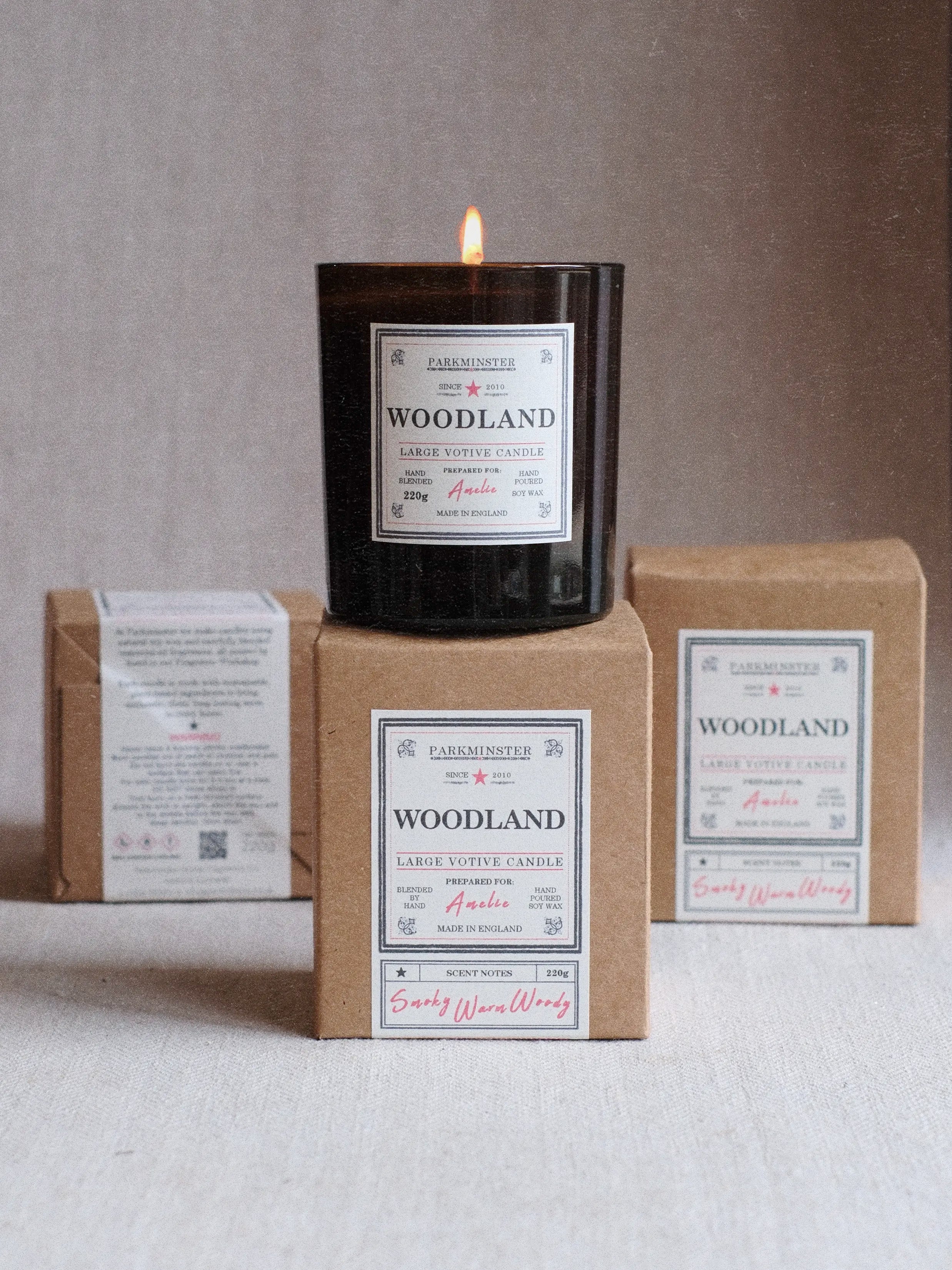 a Woodland scented Large Votive Candle with Smoky Warm and Woody scent notes made by Parkminster and packaged in natural kraft paper box